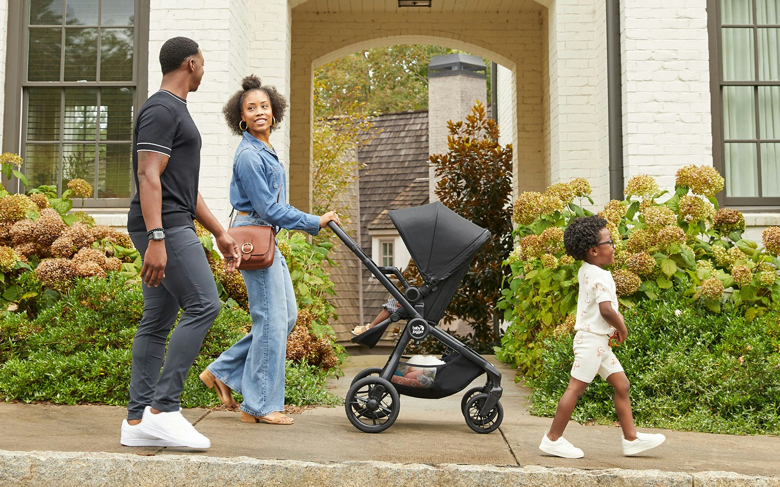 family out with baby inside city sights stroller
